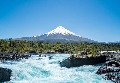 Vicente P&eacute;rez Rosales National Park in Chile. Use the lake shore or the rushing river falls as a natural foreground rather than zooming straight into Osorno Volcano. Calm morning waters reflect the cone clearly.