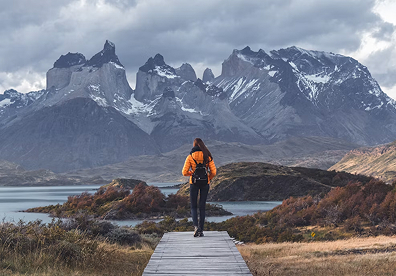 Torres del Paine National Park in Chile. Photograph early, when winds are calmer, for clearer mountain detail. Use a lake, trail, or fence line to lead the eye toward the peaks.