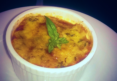 Take a photo of it intact before digging in, then take a second shot after lifting one spoonful. The cutaway reveals the corn topping and savory layers below.