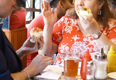 Position your camera at table level to capture the distinct colored layers from the side before the heavy mayonnaise and avocado begin to shift.