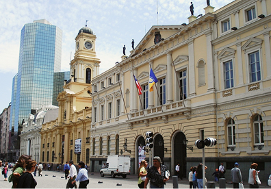 Plaza de Armas in Chile. Look around the square's four edges, where colonial government halls, neoclassical facades, and mid-century high-rises stand side by side.