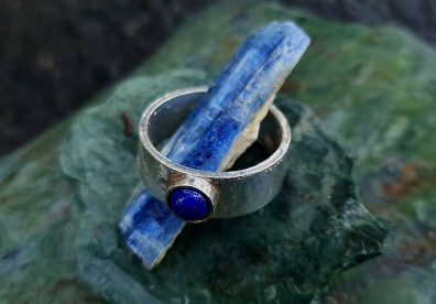 Look for a pendant, ring, or polished stone from a Chilean artisan. Ask whether the lapis is Chilean and whether the setting is solid or plated metal.